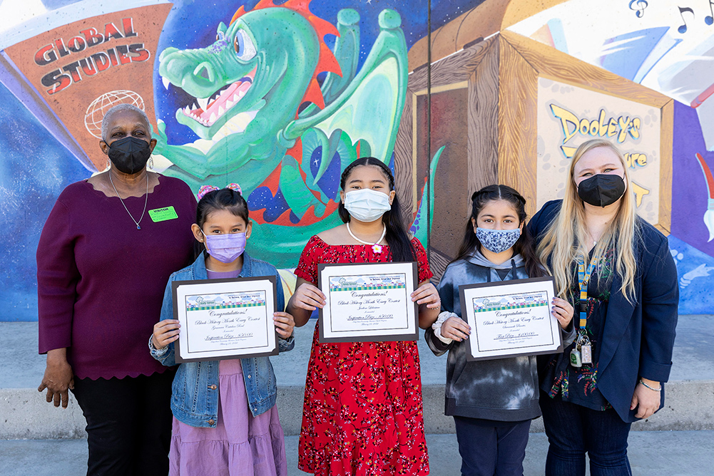 Elementary Winners- Pictured left to right: LaVerne, Inspiration winners-Genoveva Catalan Real $50, Jevilene Leleisiuao $50, First Prize winner- Savannah Puentes $100, Teacher Dionna Neally at Dooley Elementary School. Not pictured: Inspiration winner-Sophia De Leon $50.